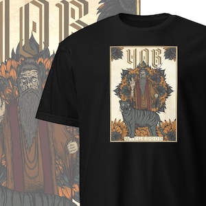 May include: Black t-shirt with a graphic of a tarot card featuring a man with a long beard and a tiger. The card is titled "WIEGEDOOD" and is surrounded by sunflowers.