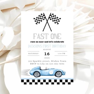 May include: A blue and white race car birthday party invitation with checkered flags, a blue race car, and the text "FAST ONE race on over and let's celebrate JACKSONS FIRST BIRTHDAY AUGUST 16 2025 1:00 PM 123 Sparkle street, Wishes Town RSVP to Lily on 123-456-7890"