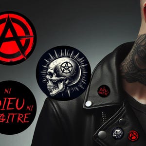May include: A selection of punk-themed badges and pins. Designs include an anarchy symbol, a skull with a pentagram, and the phrase "Ni Dieu Ni Maître" in red on black. The badges are displayed on a black leather jacket.
