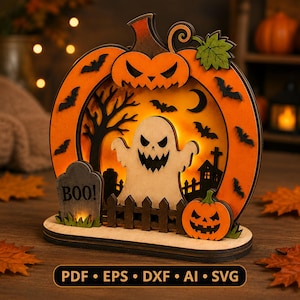 May include: A layered wooden Halloween decoration featuring a large orange pumpkin frame with a cutout ghost, a tombstone labelled BOO, a picket fence, bats, and a small pumpkin. The design includes text at the bottom reading PDF, EPS, DXF, AI, SVG.