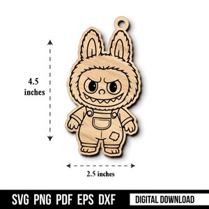 May include: Wooden cutout of a cartoon monster in a bunny costume. The character has an angry expression with sharp teeth and is wearing overalls. The cutout is 4.5 inches tall and 2.5 inches wide. The bottom of the image has the text "SVG PNG PDF EPS DXF DIGITAL DOWNLOAD".
