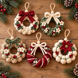 May include: Five crocheted Christmas wreath ornaments with hanging loops. One is cream with a red bow, one green with white flowers, one tan with a green bow, one red and white striped with a cream bow, and one cream with a red poinsettia.