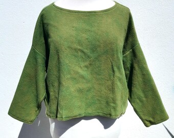 May include: A green, slightly textured, long-sleeved, cropped top with a boat neck.