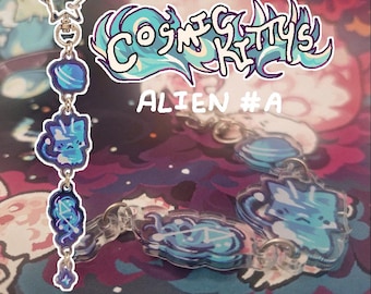 May include: A collection of Cosmic Kitty's Alien #A keychains. The keychains feature a blue and white cat design with a space theme. The keychains are connected by silver chains and a star-shaped clasp. The background is a colorful space scene.