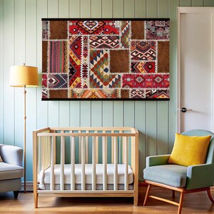 May include: A colorful patchwork wall tapestry with geometric patterns in shades of red, brown, blue, and white. The tapestry is hanging on a light green wall in a nursery setting.
