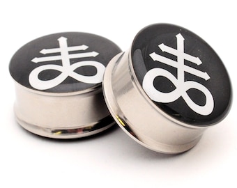 May include: Pair of black and silver stainless steel ear gauges with a white upside down cross and infinity symbol design.