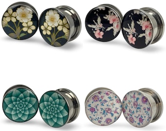 May include: A collection of six pairs of ear gauges with various floral designs. The gauges feature stainless steel tunnels and decorative faces with images of white and yellow flowers, pink flowers, teal geometric patterns, and floral patterns.