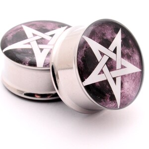 May include: A pair of silver ear gauges with a black and purple moon background and a white pentagram design.