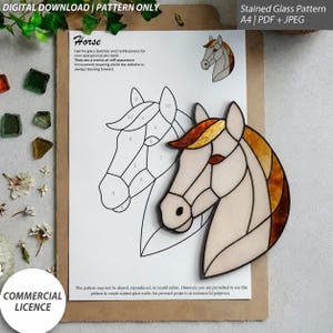 May include: A digital download stained glass pattern for a horse head, featuring a numbered line drawing on white paper and a finished stained glass horse head piece with cream, amber, and brown glass segments, labeled with the text Horse.