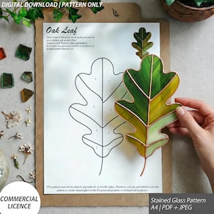 May include: A digital download stained glass pattern for an oak leaf on A4 paper. The document features a black line drawing of an oak leaf with numbered sections and a finished green and yellow glass oak leaf piece held over the paper.