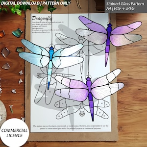 May include: A stained glass pattern for a dragonfly with numbered sections. The pattern is available in PDF and JPEG formats. The dragonfly is shown in three different colour variations: blue, purple, and pink.
