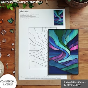 May include: A digital download stained glass pattern named "Aurora", featuring a design of the Northern Lights. The pattern is available in A4 size, PDF, and JPEG formats. The image also includes a line drawing of the pattern and the text "COMMERCIAL LICENCE".