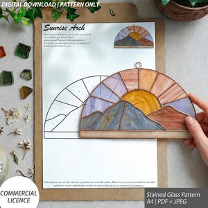 May include: A digital download stained glass pattern titled Sunrise Arch, featuring a semi-circular mountain landscape design. The document includes a numbered line drawing and a finished glass piece with purple, orange, and yellow glass segments.