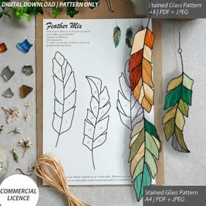 May include: A digital download stained glass pattern titled Feather Mix, featuring line drawings of three feathers with numbered segments. Two finished stained glass feather ornaments are displayed, one in orange and yellow, one in green and tan.