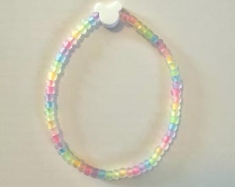 Pulseira de miçangas inspirada no Mickey - Arco-íris que brilha no escuro com miçanga branca como detalhe principal.
