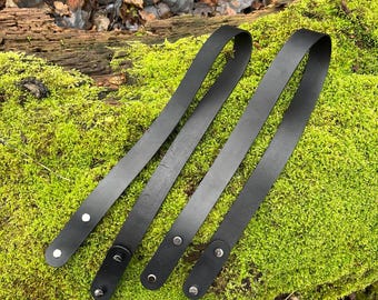 A pair of handmade leather straps, with fasteners, for knitted bags and other products