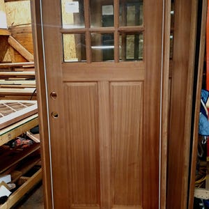 Unfinished solid Mahogany exterior door, frame, threshold, weather stripping, double paned temped glass. Made to order can be customized.