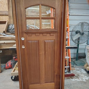Finished solid Mahogany exterior door, frame, threshold, weather stripping, and double paned temped glass. Made to order Can be customized.