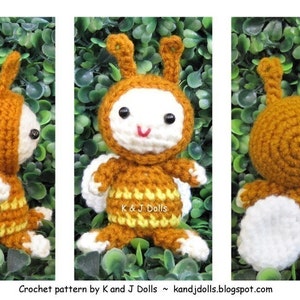 May include: A handmade crochet doll in three views. The doll has a brown head and body with white accents, including the face, wings, and feet. The doll is sitting in front of a green leafy background. The text "K & J Dolls" and a website address are visible.
