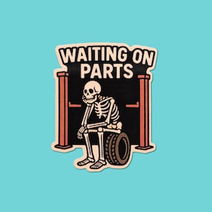 May include: A patch featuring a skeleton sitting on a tire, with the text "WAITING ON PARTS" above. The design includes a black background, red and tan accents, and a light blue background.