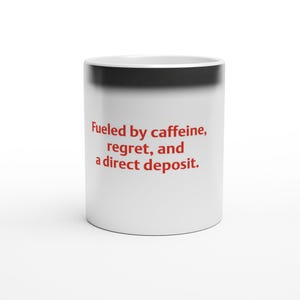 May include: A white ceramic mug with a black rim and the red text "Fueled by caffeine, regret, and a direct deposit." printed on the front. The mug has a cylindrical shape and a smooth finish, displaying the text clearly against the white surface.