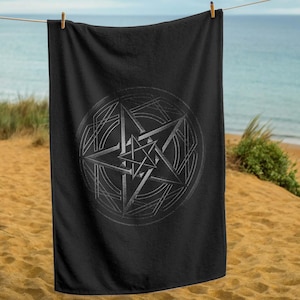 May include: Black beach towel with a silver pentagram design in the center.
