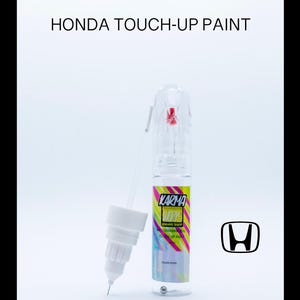 May include: A clear bottle of touch-up paint for Honda vehicles. The bottle is labeled "Karma Wax" and has a colorful design. The bottle comes with a small applicator brush.