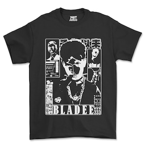 May include: A black short-sleeve t-shirt featuring a white graphic print. The design includes a central portrait, smaller inset images, Japanese characters, and the text "BLADEE 333" along with "TAKE A KNIFE AND DRAIN YOUR LIFE" and "POET ARCHIVES" on the inner neck label.