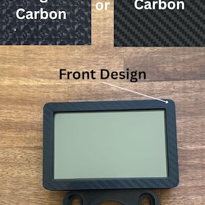 May include: A black rectangular device with a screen, mounted on a black bracket. The image shows two carbon fiber patterns, one labeled "Forged Carbon" and the other "Carbon". The text "Front Design" is also visible.