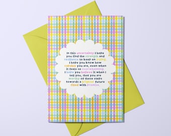 May include: A greeting card with a pastel plaid design and a white, scalloped-edged text box containing an inspirational message. A lime green envelope is visible behind the card.