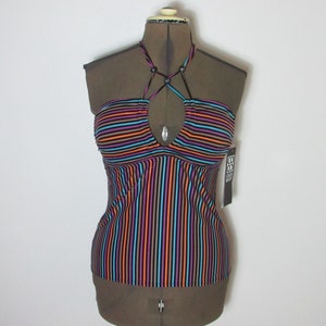 May include: A multi-colored striped halter top with a keyhole neckline. The top features vertical stripes in shades of orange, purple, blue, and black. The top is displayed on a mannequin.