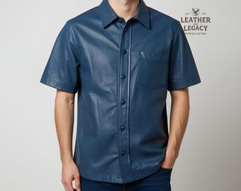 Può includere: Una camicia in pelle blu a maniche corte con chiusura a bottoni e una sola tasca sul petto. La camicia ha un'etichetta del marchio che recita "Leather and Legacy Premium Leather".