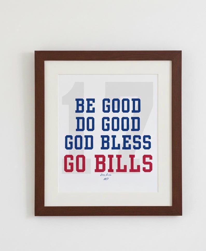 May include: Framed print with the words "BE GOOD DO GOOD GOD BLESS GO BILLS" in blue and red block letters. The print is in a brown frame with a white mat.