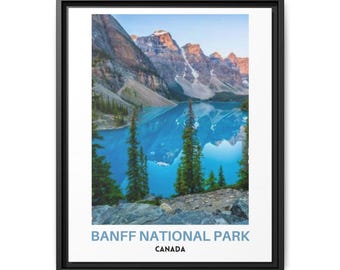 May include: A framed wall art print featuring a landscape of Banff National Park in Canada. The image displays a bright blue glacial lake surrounded by tall evergreen trees and rugged, snow-capped mountain peaks under a clear sky.