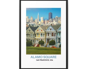 May include: A framed wall art print featuring the Painted Ladies Victorian houses in Alamo Square, San Francisco, with the city skyline in the background. The text ALAMO SQUARE SAN FRANCISCO, USA is printed in blue and black at the bottom.