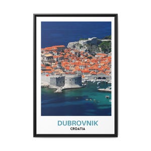 May include: An aerial view of the city of Dubrovnik, Croatia. The city is surrounded by a wall and is located on a peninsula. The water is a deep blue and there are boats in the harbor. The text "DUBROVNIK CROATIA" is at the bottom of the image.