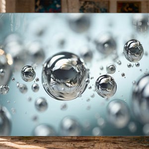 May include: Close-up of a collection of clear, spherical bubbles, reflecting light and creating a shimmering effect. The bubbles vary in size, with some appearing larger and more defined, while others are smaller and more blurred, against a light blue background.