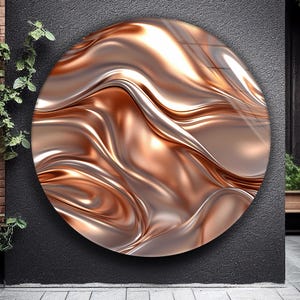 May include: A round wall art piece with a metallic, flowing design in shades of copper and silver. The artwork has a glossy finish, creating a sense of depth and movement. The piece is mounted on a dark gray wall, adding contrast.