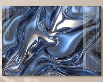 May include: Abstract art print with a flowing, liquid design in blue and silver tones. The artwork has a glossy, reflective finish, giving an impression of depth and motion. The piece is mounted on a neutral background.