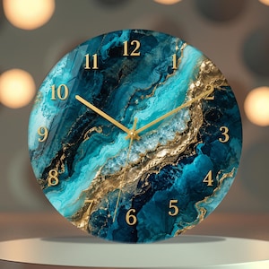 May include: A round wall clock featuring a vibrant teal, navy blue, and gold marbled pattern across its face. The clock has gold-coloured hands and raised gold-coloured numerals from 1 to 12 arranged in a circular layout against the swirling design.