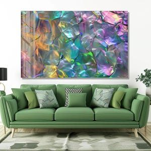 May include: Abstract wall art showing iridescent, textured shapes in purple, green, and gold. The artwork is displayed above a green sofa with various throw cushions.