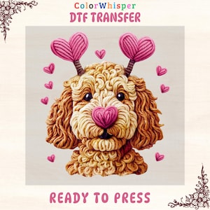 May include: A DTF transfer design of a dog with a heart-shaped nose and antlers. The dog is crafted from yarn in brown and cream hues, with pink hearts scattered around. The text "ColorWhisper DTF TRANSFER" and "READY TO PRESS" are displayed.