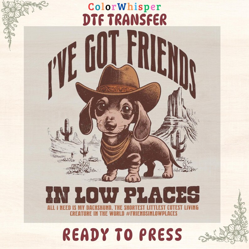 May include: A DTF transfer featuring a dachshund wearing a cowboy hat and bandana, set against a desert landscape. The text reads "I'VE GOT FRIENDS IN LOW PLACES" and "READY TO PRESS". The design includes the text "ALL I NEED IS MY DACHSHUND, THE SHORTEST LITTLEST CUTEST LIVING CREATURE IN THE WORLD #FRIENDSINLOWPLACES".