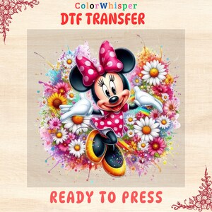 May include: A colorful DTF transfer featuring a cartoon image of Minnie Mouse with a red bow and polka dot dress. She is surrounded by colorful flowers and a rainbow. The text "READY TO PRESS" is at the bottom of the image.