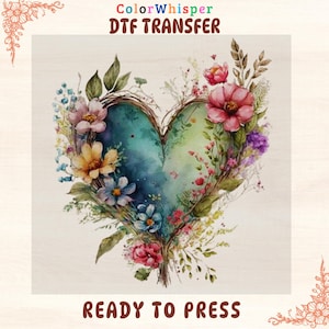 May include: A watercolor design featuring a heart shape filled with blue and green hues, surrounded by colorful flowers and greenery. The text "ColorWhisper DTF TRANSFER" and "READY TO PRESS" are displayed.