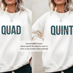 May include: Two white sweatshirts with customizable text. The first sweatshirt has the text "QUAD" in teal with the word "mama" in pink underneath. The second sweatshirt has the text "QUINT" in teal with the word "mama" in pink underneath.