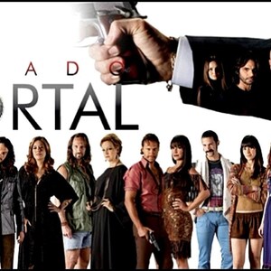 May include: A group of people stand in front of a white background with a large red title that reads "PECADO MORTAL" with a disco ball in the middle of the word "MORTAL". A hand holding a gun is coming out of the top of the image.