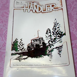 May include: Vintage magazine cover titled "The Handler" with a drawing of a jeep on a trail. The cover is white with brown and green accents, and the text includes "No. 1 March 1977" and "$1". The magazine is for CBers in Northcentral Idaho, Southeastern Washington, and Northeastern Oregon.