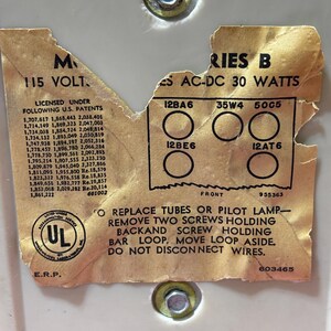 May include: Close-up of a vintage electronic component label. The label is tan with black text, including "115 VOLT" and "SERIES B AC-DC 30 WATTS." It lists tube types and instructions for replacement. The UL logo is visible.