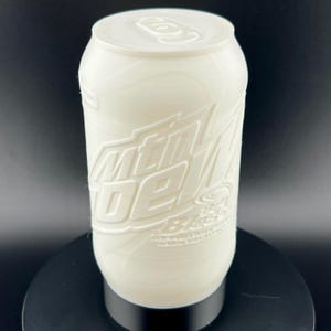 May include: White plastic can with the words "Mountain Dew" embossed on the side. The can has a black lid and a black base.